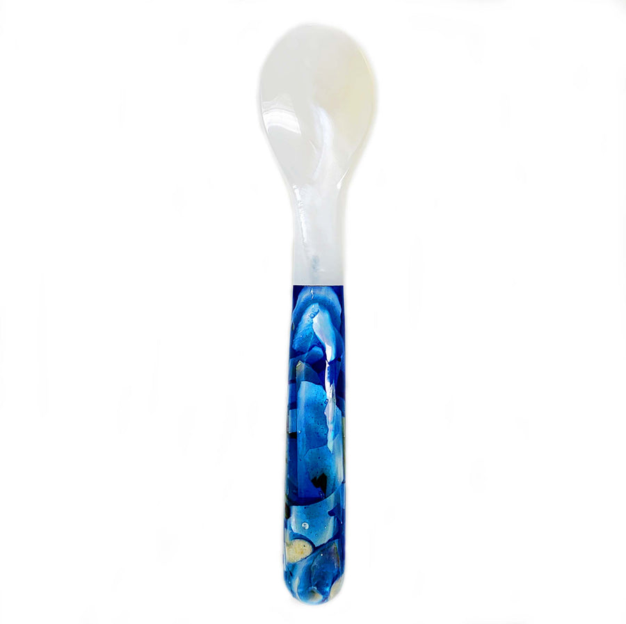 a mother of pearl spoon with blue wooden handle